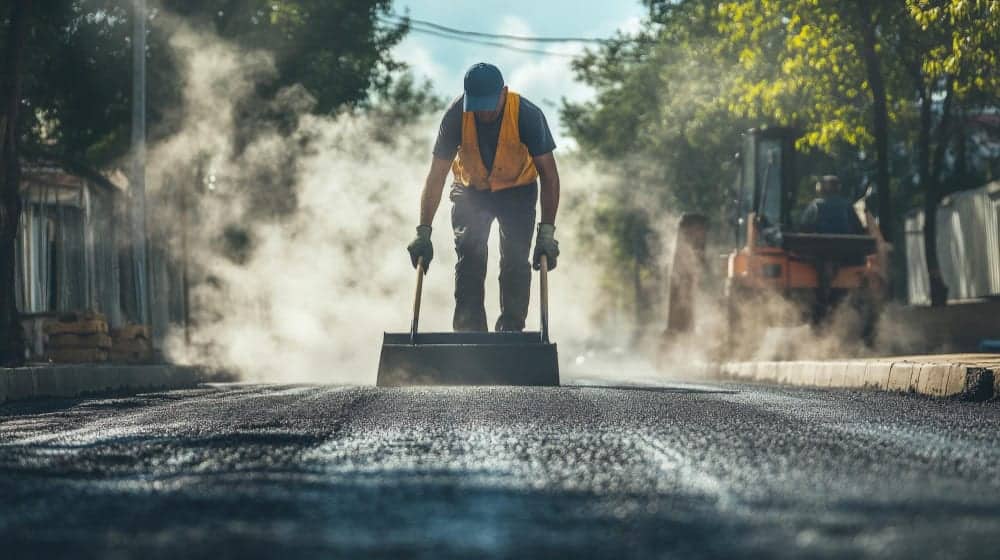 A crew applying driveway sealer on a warm, sunny afternoon in the Greater Toronto Area.